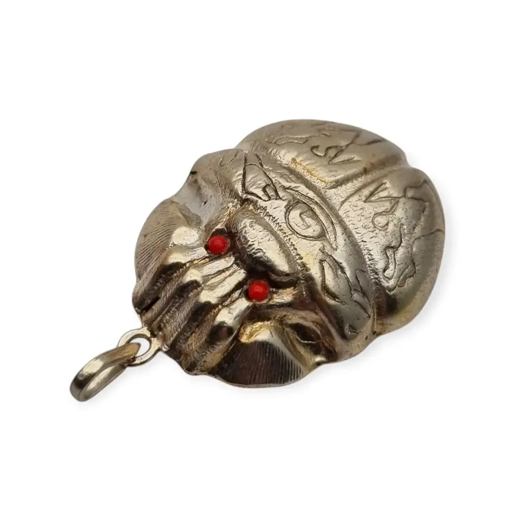 Antique Egyptian scarab amulet made of silver and hieroglyphic engravings, 1980.