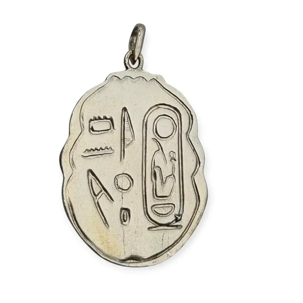 Antique Egyptian scarab amulet made of silver and hieroglyphic engravings, 1980.