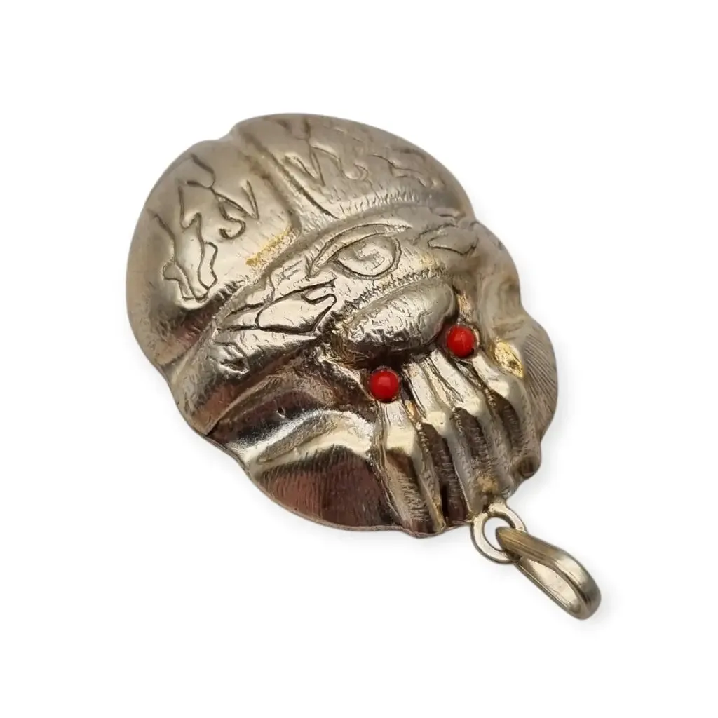 Antique Egyptian scarab amulet made of silver and hieroglyphic engravings, 1980.