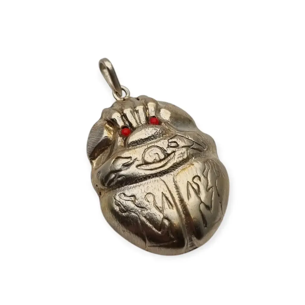 Antique Egyptian scarab amulet made of silver and hieroglyphic engravings, 1980.