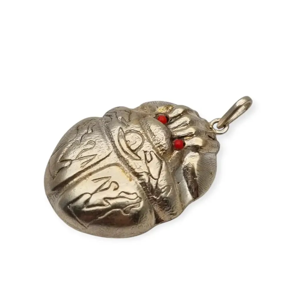 Antique Egyptian scarab amulet made of silver and hieroglyphic engravings, 1980.